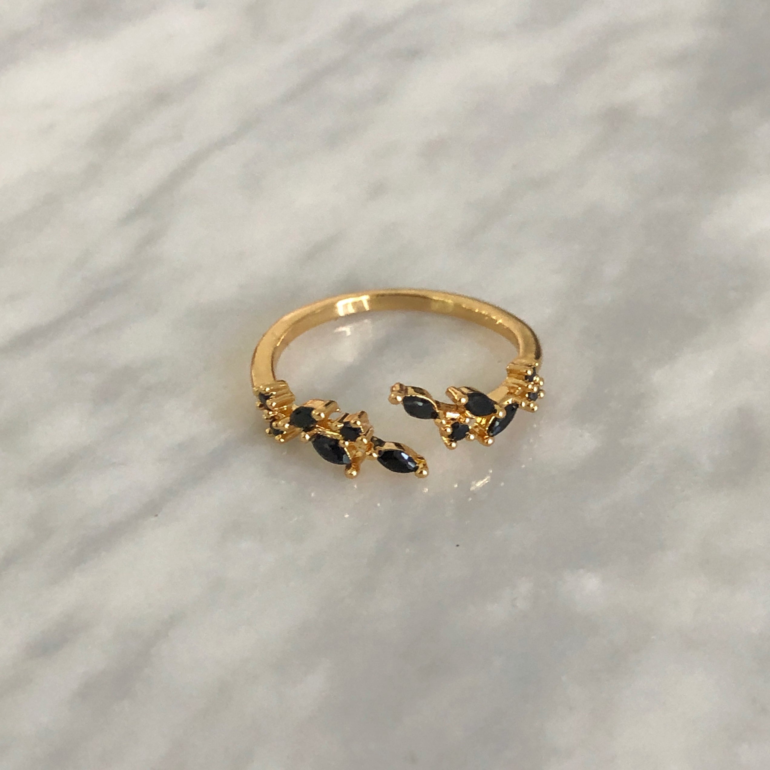 Close-up of black Adeline ring's detailed zircon arrangement and dramatic teardrop center stone