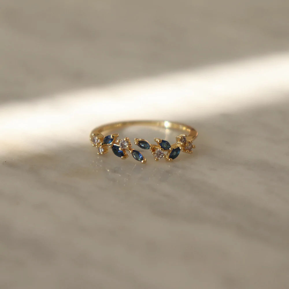 Blue zircon Adeline ring featuring aquatic tones in intricate leaf pattern