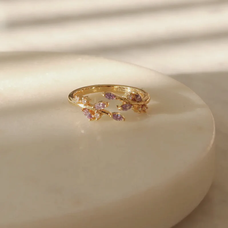 Purple zircon Adeline leaf ring on finger, highlighting regal tones and sparkling stone arrangement