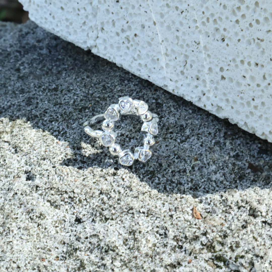 Detailed shot of the Maelie zircons, showcasing their delicate sparkle and subtle, sweet heart-like silhouette outlines.