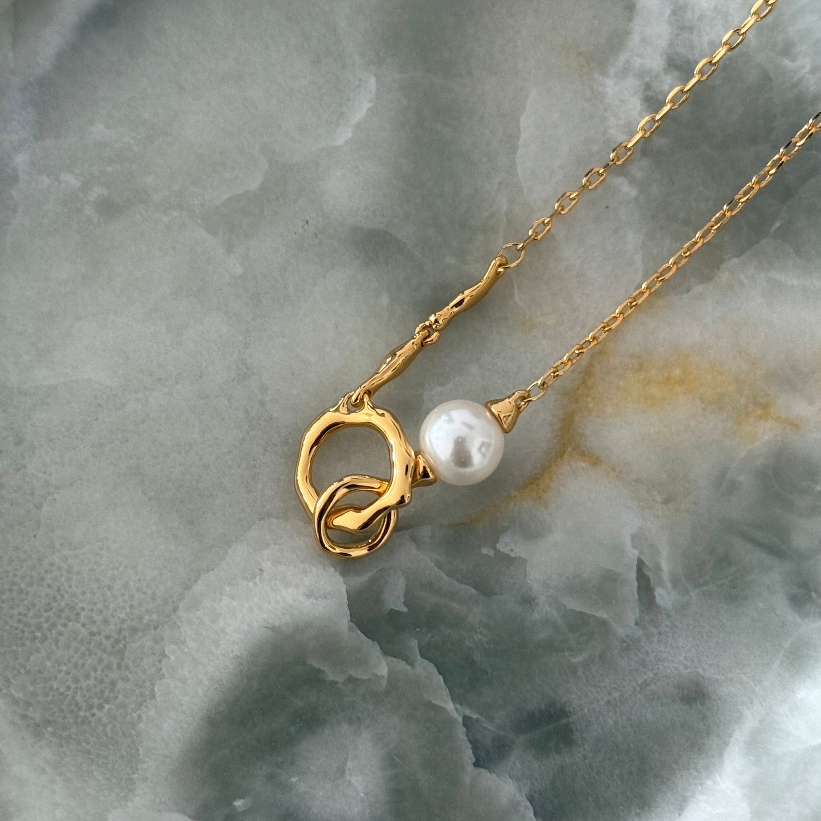 Detailed view of yellow gold Sonnet pendant, showcasing warm tones complementing the freshwater pearl