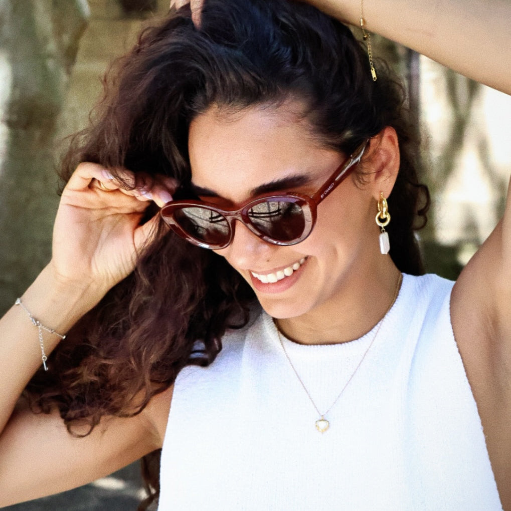 Stylish unisex cat-eye sunglasses by By Charley, featuring a rich reddish-brown frame and polarized lenses that offer 100% UV protection and glare reduction for a confident, retro-inspired statement.