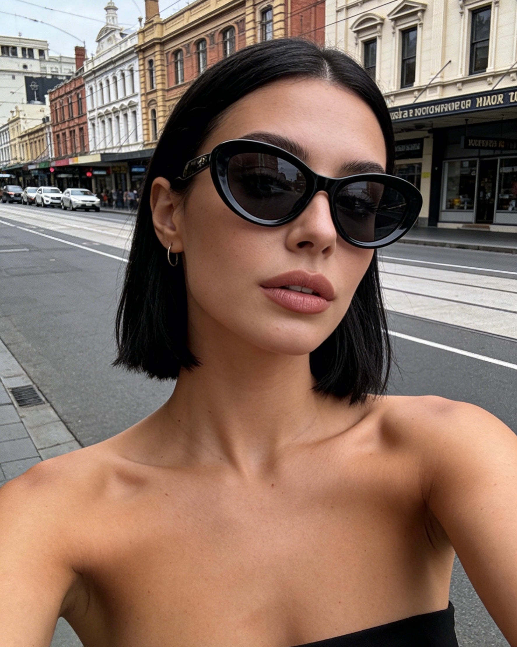 Classic black bold frame cat-eye sunglasses with polarized lenses and UV protection, aesthetic minimalist eyewear.