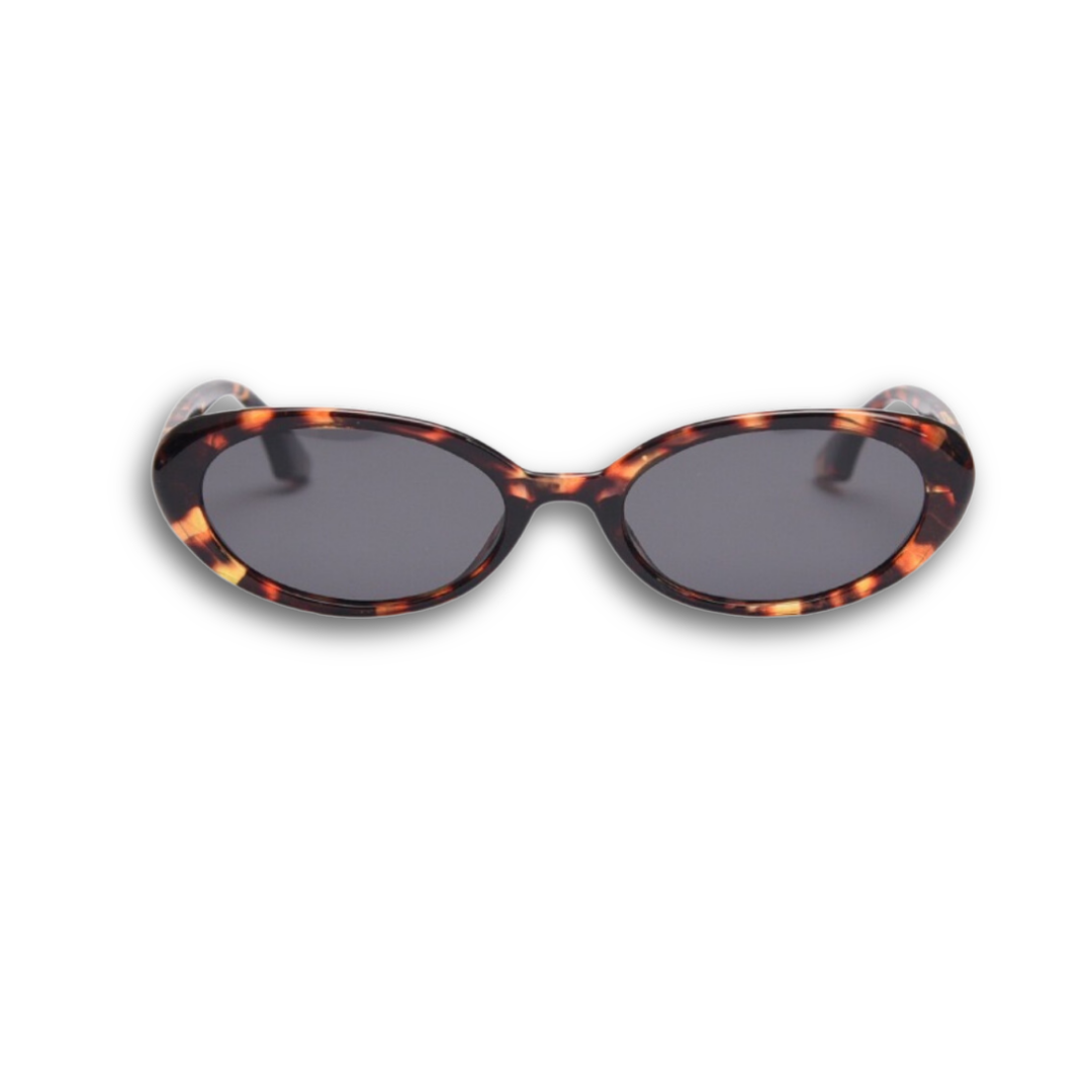 Playful and retro unisex oval sunglasses by By Charley, featuring a distinctive tortoiseshell frame and polarized lenses that offer 100% UV protection and glare reduction for a unique, fashion-forward look.